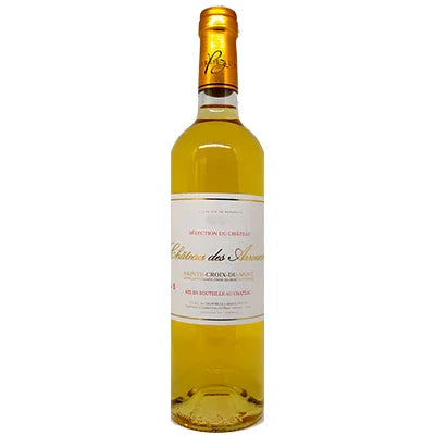 French dessert wine bottle with golden liquid and white label on plain background