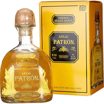 Añejo tequila bottle with cork and yellow gift box, labeled 100% de agave, 1 litre, 40% alcohol.