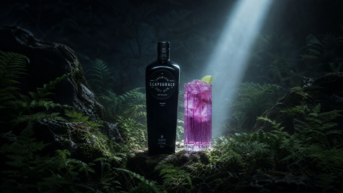 Scapegrace Dry Gin bottle and purple cocktail in misty forest with spotlight