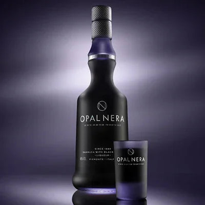 Opal Nera black sambuca liqueur bottle and branded glass on dark background
