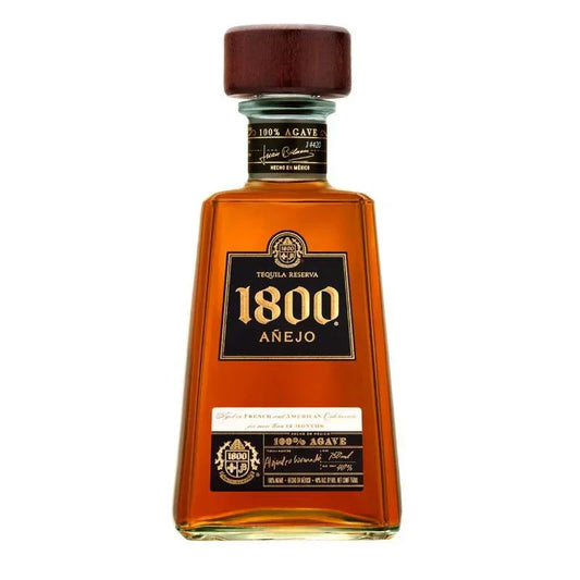 1800 Añejo Tequila bottle with amber liquid and wooden cap on white background