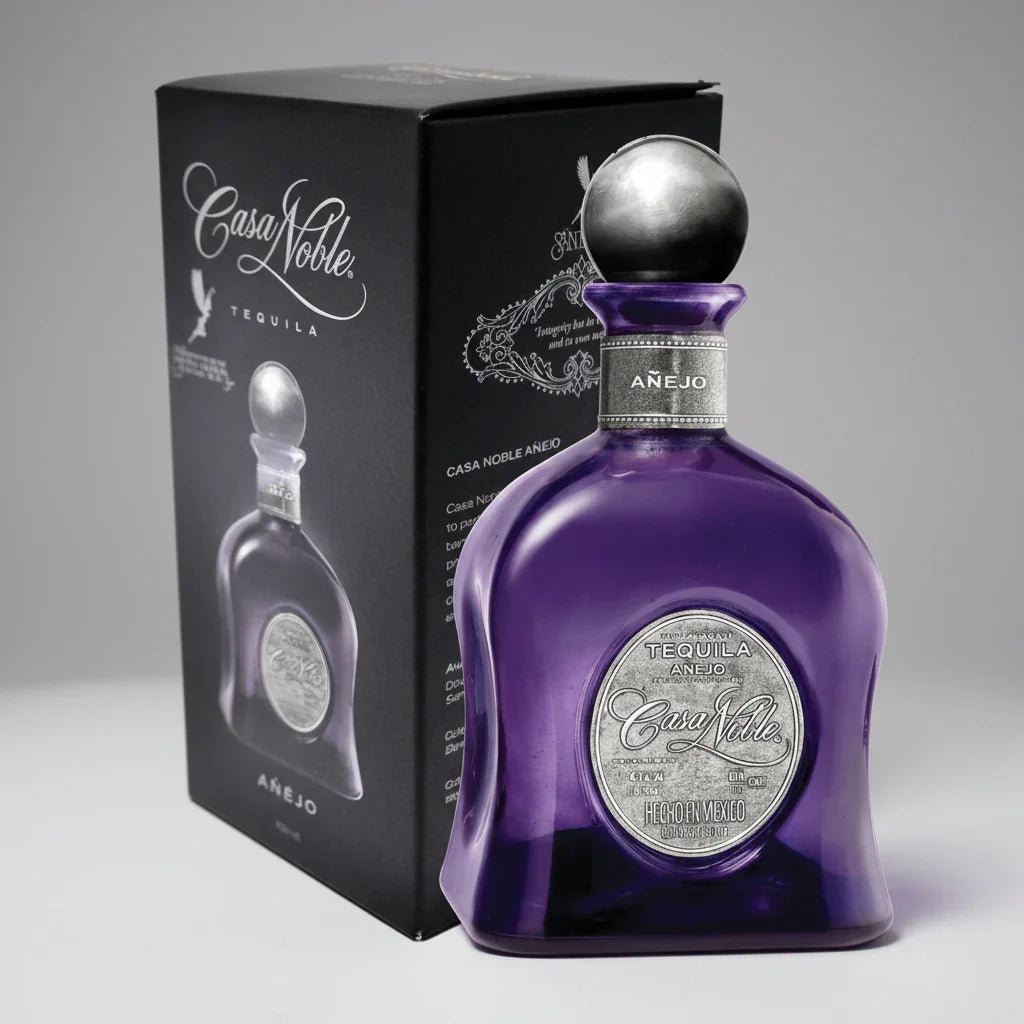 Purple Casa Noble Añejo tequila bottle with silver cap and box on a white background