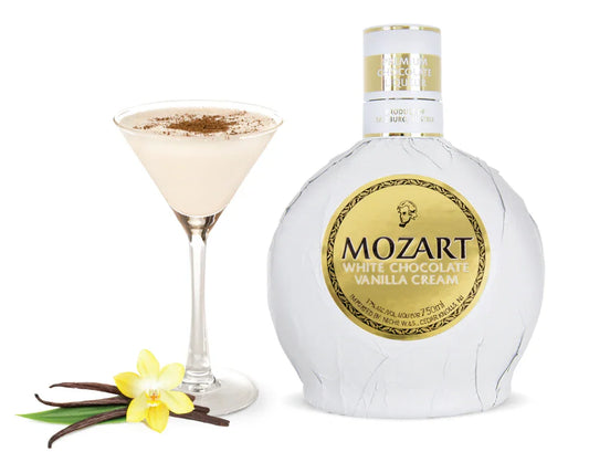 Mozart White Chocolate Vanilla Cream liqueur bottle with a creamy cocktail, vanilla flower, and pods