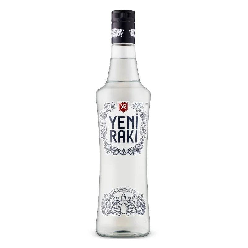 Clear bottle of Yeni Raki Turkish anise spirit with decorative label on white background.