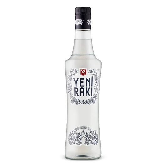 Clear bottle of Yeni Raki Turkish anise spirit with decorative label on white background.
